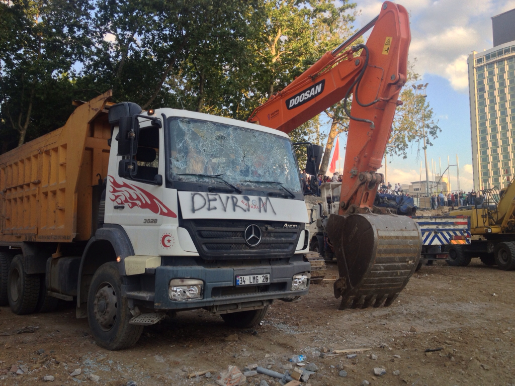 Construction equipment was smashed and graffitied. "Devrim" means "revolution".